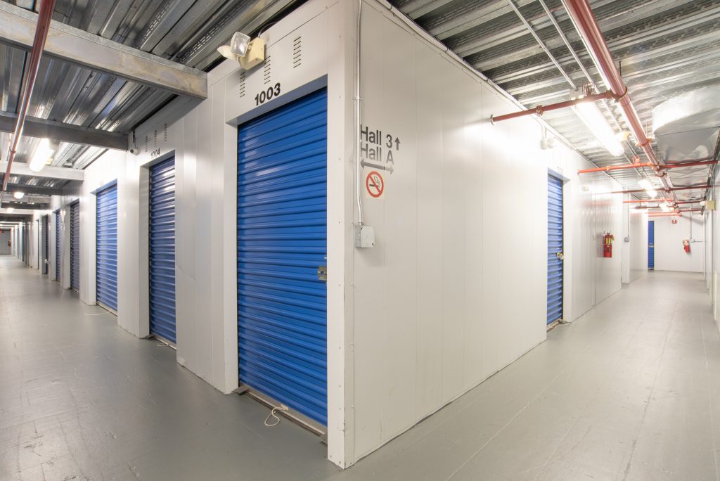 Corner view of Shrewsbury location's indoor storage units with blue doors