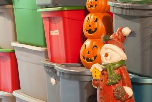 Plastic storage bins, filled with decorations for various holidays